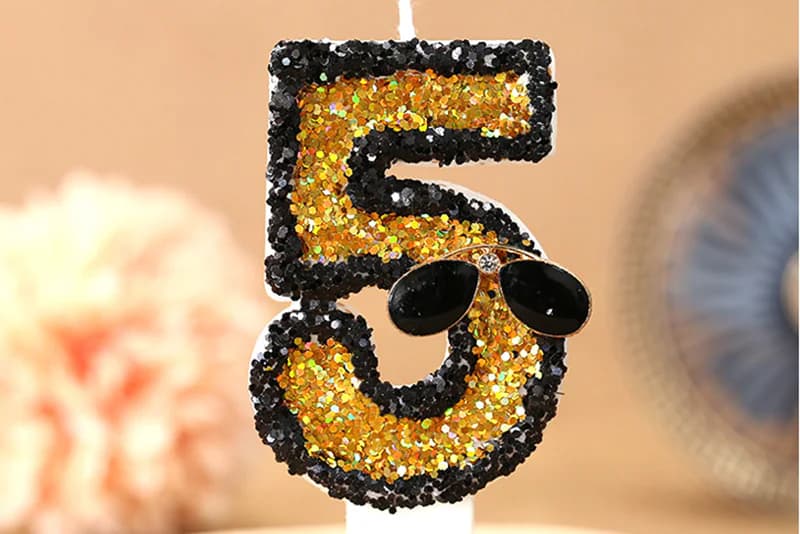Creative black traced digital sunglasses adorn birthday candle